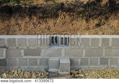Construction Of Stone Walls Of A Building From Hollow Concrete Blocks On Heavy Granite Gravel. Mason