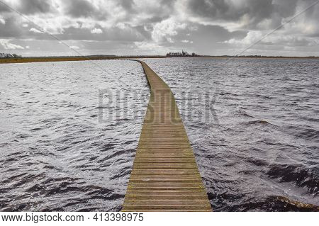 Wooden Walking Path Over The Waves Of The Lake In Roegwold, Netherlands