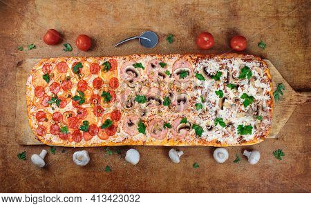 Long Pizza Mix Lies On A Wooden Table. Roman Pizza On A Wooden Spatula. The Pizza Is One Meter Long.