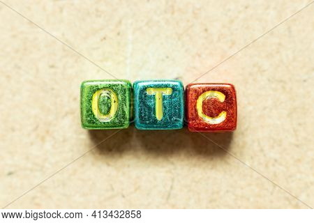 Metallic Color Alphabet Letter Block In Word Otc (abbreviation Of Over The Counter)  On Wood Backgro