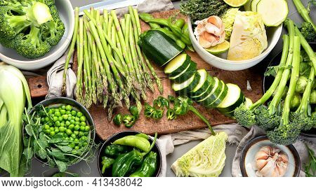 Set Of Various Green Raw Healthy Vegetables On Wooden Board