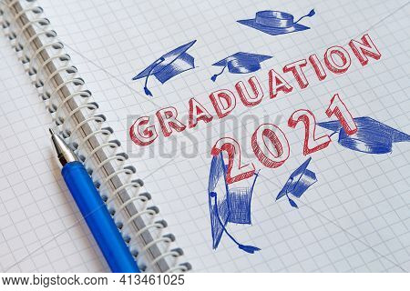 University Graduates Throwing Academic Caps Up. Text Graduation 2021 And Academic Caps Drawn On Shee