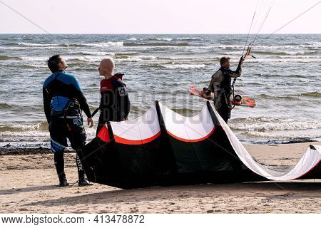 Young People Get Their Gear To Go Kiteboarding In The Gulf Of Riga On October 21, 2020 At Cape Kolka