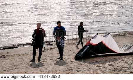 Young People Get Their Gear To Go Kiteboarding In The Gulf Of Riga On October 21, 2020 At Cape Kolka