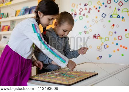 Using Wooden Geoboard At Primary School Classroom