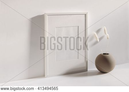 Modern Summer Stationery Still Life Scene. Beige Ball Shaped Vase With Dry Lagurus Grass In Sunlight