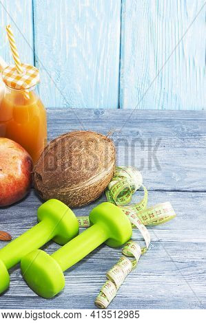 A Bottle Of Juice, Fruit, A Measuring Tape On A Wooden Textured Background. Fitness, Sports Nutritio