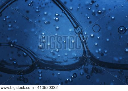 Blue Liquid Gel Cosmetic Smudge Texture. View Of Microscope. Selective Soft Focus