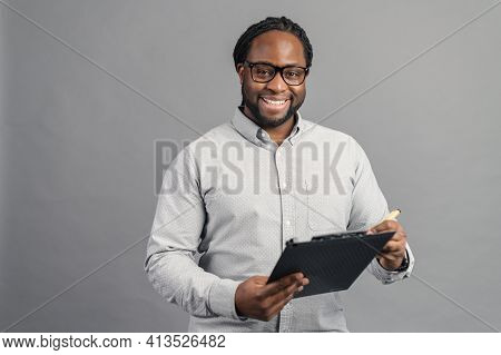 African American Hr Employee In A Formal Shirt With Eyeglasses Standing With Black Clipboard, Positi