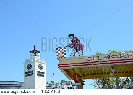 LOS ANGELES - MARCH 28, 2018: Farmers Market Clock Tower and Gilmore sign. First opened in July 1934, it is a historic Los Angeles landmark and huge tourist attraction.