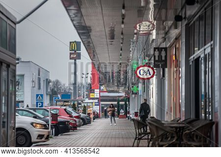 Pancevo, Serbia - March 21, 2021:  Selective Blur On A Woman Wearing A Facemask Using Her Phone In A