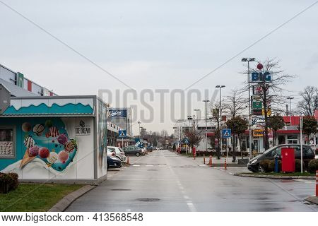 Pancevo, Serbia - March 21, 2021: Locked Shops And Stores And Empty Parking Lot Of A Closed Mall In 