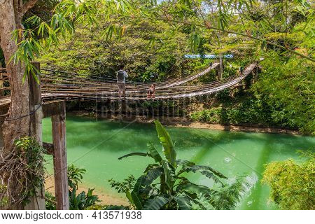 Bohol, Philippines - Feb 11, 2018: Tourists Taking Photo On The Sipatan Twin Hanging Bridge Over Lob