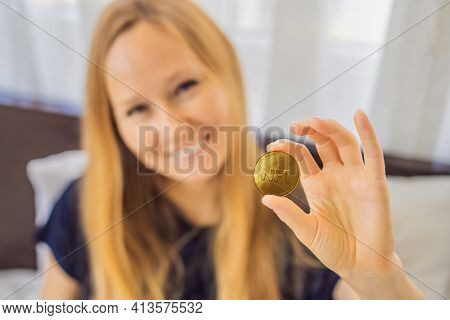 Nft Young Woman, A Digital Artist, Creates Digital Art On A Tablet At Home And Shows A Coin With The