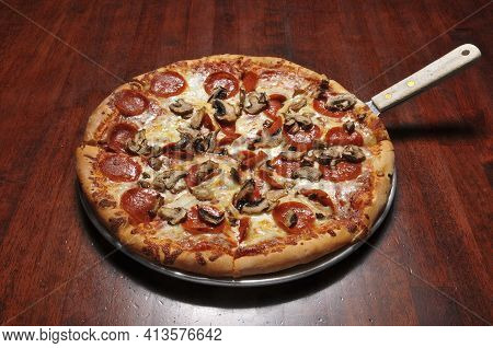 Delicious Tomato Sauce Cheese Covered Hot And Tasty Pepperoni Mushroom Pizza Pie