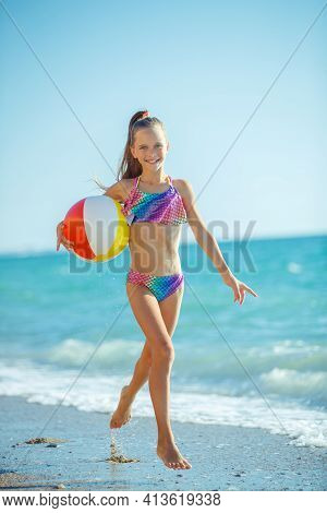 Child Girl Runs On The Waves. Rest By The Sea, Fun Outdoors. High Quality Photo.