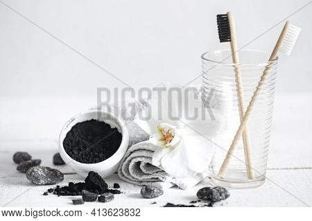 Still Life With Organic Bamboo Brushes And Activated Carbon Powder And An Orchid Flower As A Decorat