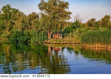 A Hut Under A Tree On The Coast Of The Konka River In Kherson (ukraine). Natural Landscape Of A Rese