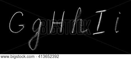 Uppercase And Lowercase Letters G, H, I Of The English Alphabet Written By Hand In Chalk On A Blackb