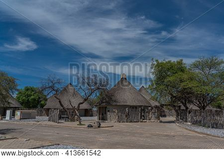 Okaukuejo, Namibia - January 14, 2020 : Okaukuejo Resort With Thatched Roof Houses And Campsite In E