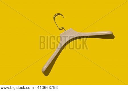 Plastic Fashionable Hanger Under A Tree On A Yellow Background With A Hard Shadow. Concept Store, Sa