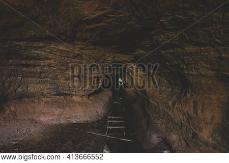 Man In Natural Cave In The Park At The Rozhdestveno Estate, Near The Town Of Gatchina In The Leningr
