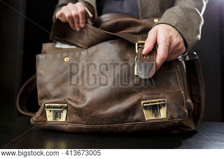 Hands Professor Open Buckle On The Old Leather Briefcase, Before Class. Education Concept.