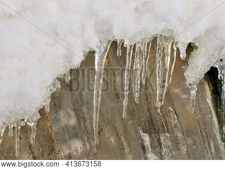 Close Up Freezing Cold And Icicles Hanging Down On Window