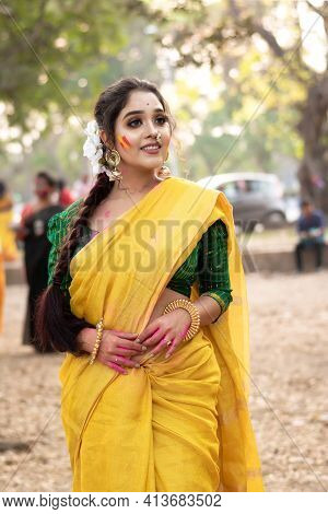 Portrait Of Beautiful Happy Young Indian Woman With Spring Festive Make Up Celebrating Holi With Pow