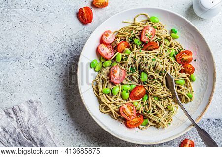 Green Vegan Edamame Pasta With Tomatoes And Beans. Plant Based Diet Concept.