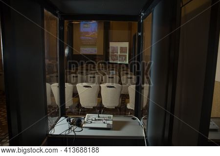 Soft Focus Of Wireless Conference Microphones And Notebook In A Meeting Room. Translators Cubicle . 