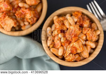 Pork Stew With White Beans In A Wooden Bowl.