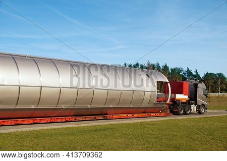 Oversize Load Or Exceptional Convoy. A Truck With A Special Semi-trailer For Transporting Oversized 