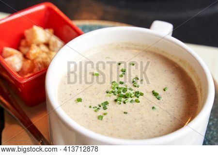 Creamy Onion Soup With Green. Health Food At Cafe. Classic Cuisine. Cooking Bowl With Bread Croutons