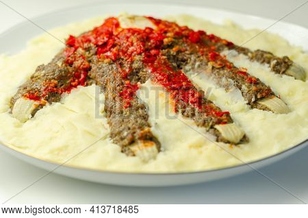 Roasted Minced Meat Formed In The Shape Of A Hand, Topped With A Tomato And Pepper Sauce, A Creative
