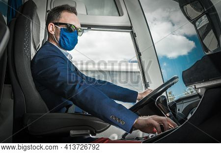 Caucasian Bus Coach Driver In His 40s Wearing Pandemic Mask Preparing Vehicle For The Road. Public T
