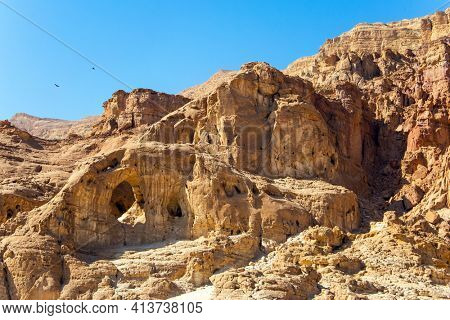 Magnificent multi-colored rocks. Arch as a result of weathering. The Timna Valley in the south of the Arava Desert, near the resort of Eilat. Israel. Hot November day. 