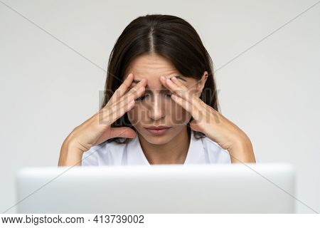 Woman Feeling Headache, Weakness, Tired, Exhausted From Work On Laptop At Home Office Over Grey Wall