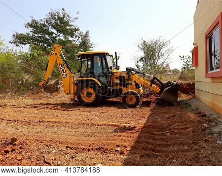 Closeup Of Jcb Cleaning Land For Construction Of Building At Forest Or Countryside