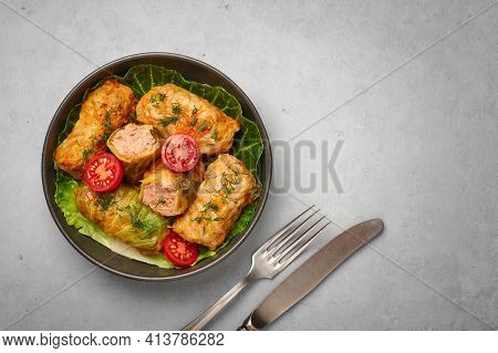 Golubtsi Or Golabki On Black Bowl On Concrete Table Top. Stuffed Cabbage Rolls Dish Of Russian, Poli