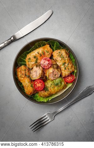 Golubtsi Or Golabki On Black Bowl On Concrete Table Top. Stuffed Cabbage Rolls Dish Of Russian, Poli