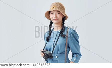 Attractive Energetic Asian Woman Happily Holding Cemara Isolated On Gray Background