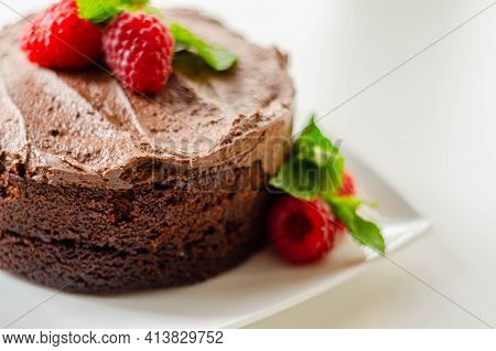 Gluten Free Tasty Round Cake Based On Belgian Chocolate Decorated With Fresh Raspberries And Mint, D