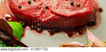 Raw Beef Sirloin Steak With Peppercorns And Garlic Prepared For Frying