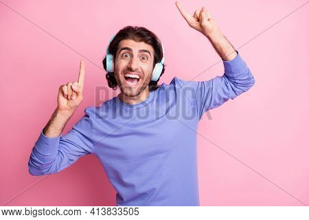 Photo Of Young Excited Smiling Cheerful Man Point Fingers In Copyspace Listen Music Earphones Isolat