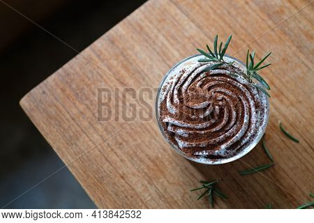 Banoffee With White Cream And Chocolate Powder On Wood Table Background, Top View