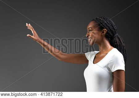 Woman reacing out and touching invisible screen