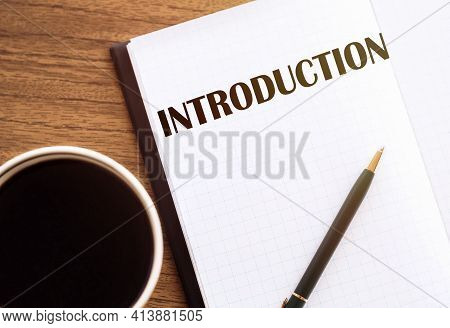 Introduction - Text On Notepad On Wooden Desk.