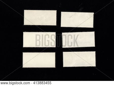 Reverse Side Of Stamp Isolated On Black Background. Postage Stamps On Other Side. Blank Postage Stam