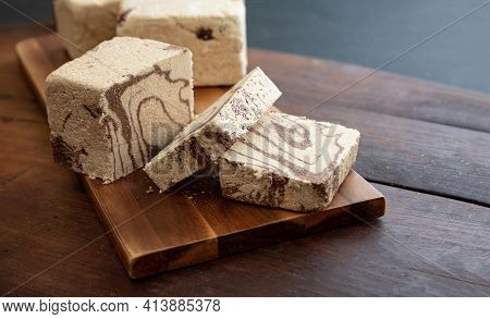 Halva Cocoa Slices On Wooden Table Background, Closeup View.
